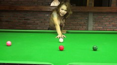 Inked beauty Kate bends over the billiard table to show off some curves
