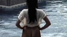 Satomi stands in the pool and moves her clothes around to give a show
