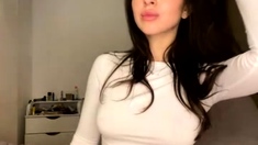 Busty babe playing with her big boobs