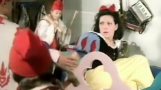 Snow White plays with a thick long candle for her seven dwarves